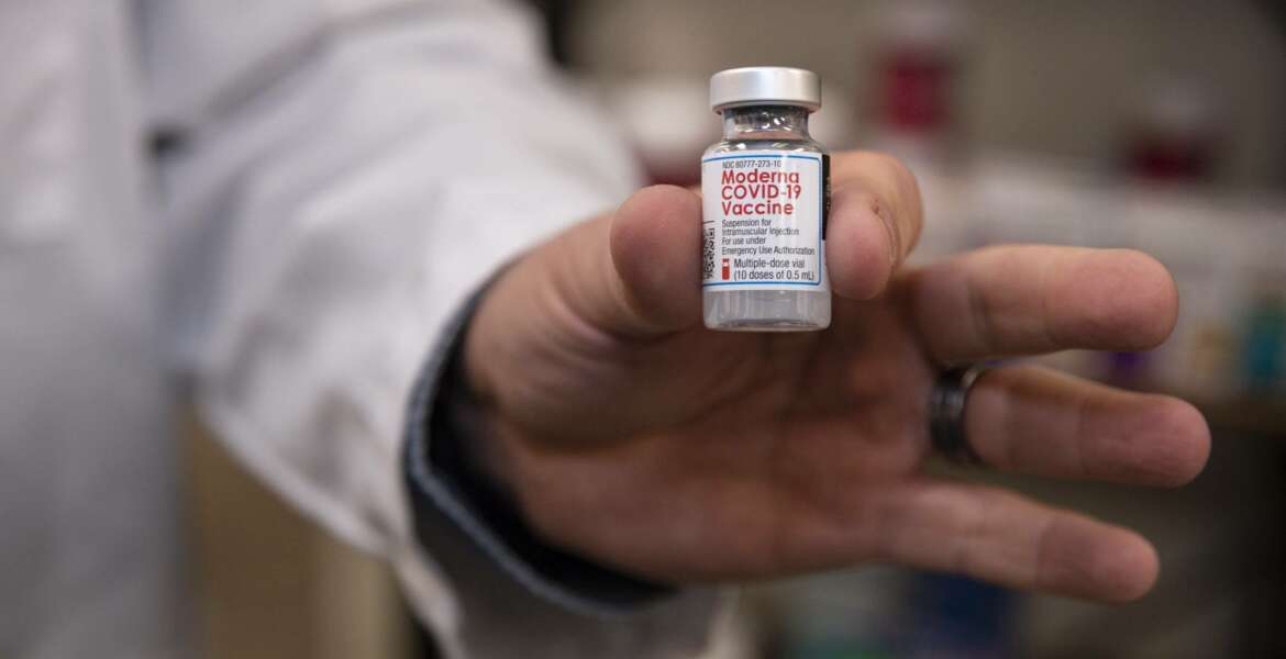 Pharmacist Brian Meyer holds a Moderna COVID-19 vaccine vial for a photo on Tuesday, Jan. 5, 2021 at Sunflower Pharmacy in Odessa, Texas. Sunflower Pharmacy is the first privately owned pharmacy in Odessa given to permission to distribute the vaccine. (Eli Hartman/Odessa American via AP)