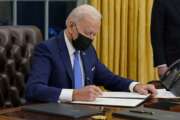 President Joe Biden signs an executive order on immigration, in the Oval Office of the White House, Tuesday, Feb. 2, 2021, in Washington. (AP Photo/Evan Vucci)