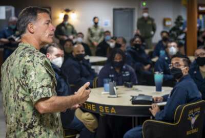 In this Feb. 8, 2021, photo provided by the U.S. Navy, Adm. John Aquilino, commander, U.S. Pacific Fleet, speaks with sailors assigned to the USS Carl Vinson (CVN 70). Senior U.S. Navy commanders met with sailors on ships on the West Coast Monday and Tuesday, after two recent racist incidents triggered one of the first military stand-downs to address extremism in the ranks. (Mass Communication Spc. Seaman Apprentice Mason Congleton/U.S. Navy via AP)