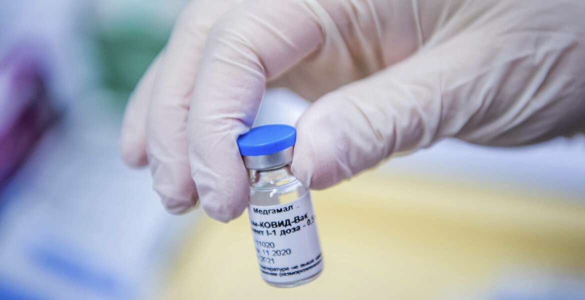 A vial containing Russian vaccine Sputnik V is shown by a nurse at the South Pest Central Hospital in Budapest, Hungary, Friday, Feb. 12, 2021, as the vaccination with Sputnik V against the new coronavirus begins in the country. (Zoltan Balogh/MTI via AP)