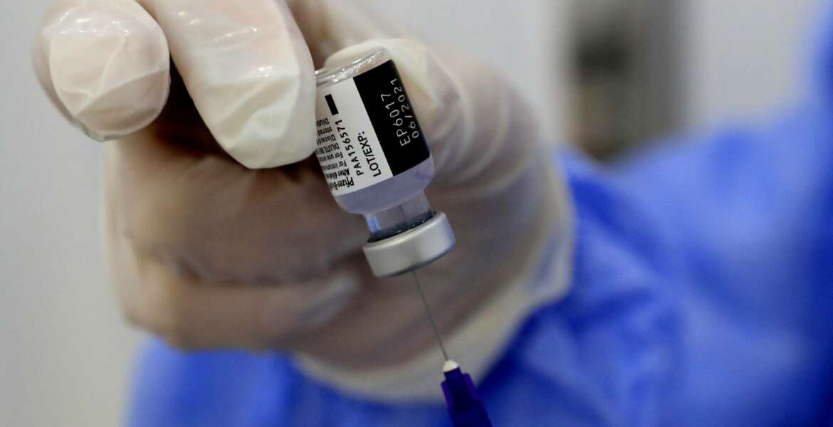 A nurse prepares a syringe of the Pfizer-BioNTech COVID-19 vaccine during a nationwide vaccination campaign, at the Saint George Hospital, in Beirut, Lebanon, Tuesday, Feb. 16, 2021. Lebanon launched its inoculation campaign after receiving the first batch of the vaccine — 28,500 doses from Brussels with more expected to arrive in the coming weeks. (AP Photo/Hussein Malla)