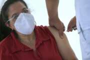 A woman gets her shot of the AstraZeneca COVID vaccine at the Magdalena Contreras borough of Mexico City, Tuesday, Feb. 16, 2021, as Mexico begins to vaccinate people over the age of 60 against the new coronavirus. (AP Photo/Marco Ugarte)