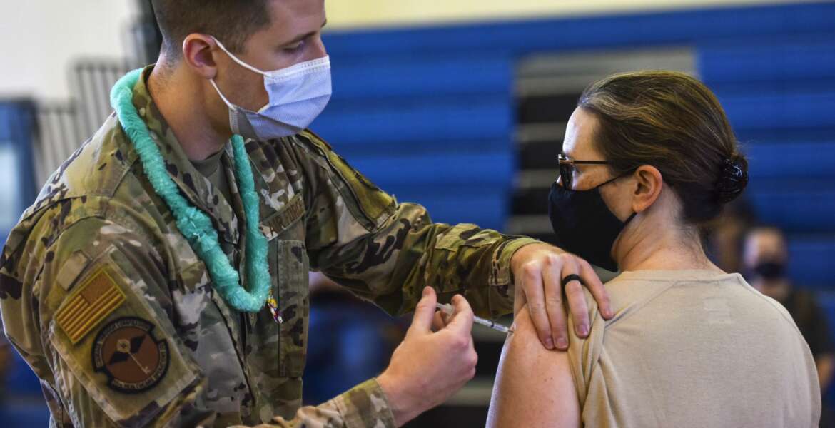 In this Feb. 9, 2021 photo provided by the Department of Defense, Hickam 15th Medical Group host the first COVID-19 mass vaccination on Joint Base Pearl Harbor-Hickam. By the thousands, U.S. service members are refusing or putting off the COVID-19 vaccine, as frustrated commanders scramble to knock down internet rumors and find the right pitch that will convince troops to take the shot. Some Army units are seeing as few as a third agree to the vaccine, others are higher. (U.S. Air Force Tech. Sgt. Anthony Nelson Jr./Department of Defense via AP)