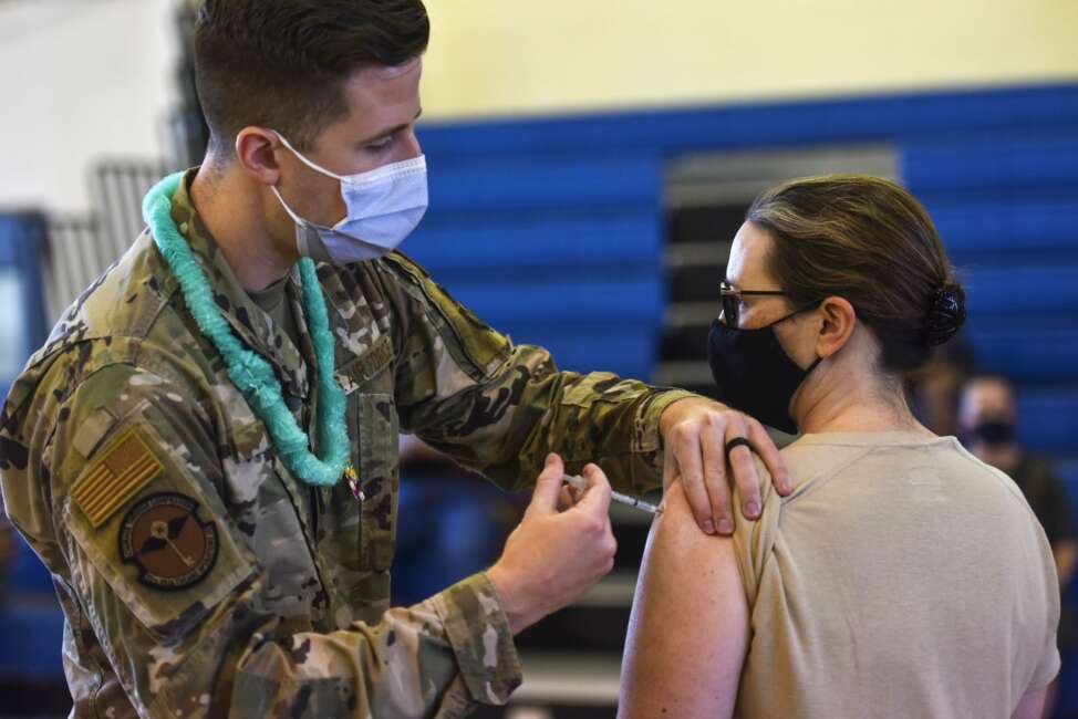 In this Feb. 9, 2021 photo provided by the Department of Defense, Hickam 15th Medical Group host the first COVID-19 mass vaccination on Joint Base Pearl Harbor-Hickam. By the thousands, U.S. service members are refusing or putting off the COVID-19 vaccine, as frustrated commanders scramble to knock down internet rumors and find the right pitch that will convince troops to take the shot. Some Army units are seeing as few as a third agree to the vaccine, others are higher. (U.S. Air Force Tech. Sgt. Anthony Nelson Jr./Department of Defense via AP)