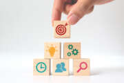 Concept of business strategy and action plan. Hand putting wooden cube block stacking with icon on white background