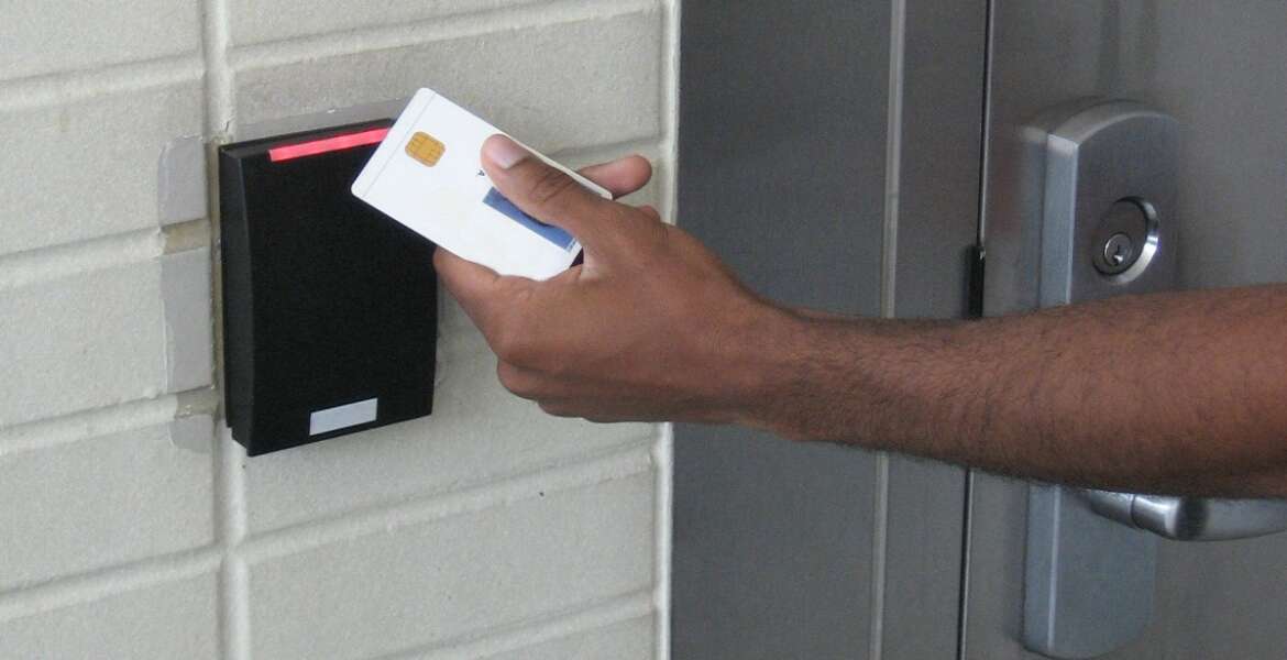 An employee swipes their personal identity verification (PIV) card