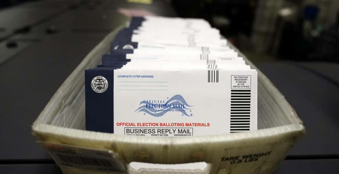 FILE - In this Oct. 23, 2020, file photo mail-in ballots for the 2020 General Election in the United States are seen before being sorted at the Chester County Voter Services office in West Chester, Pa. A new study finds the expansion of mail voting did not benefit Democrats or increase turnout. (AP Photo/Matt Slocum, File)