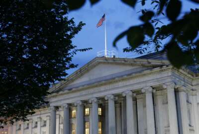 FILE - This Thursday, June 6, 2019, file photo shows the U.S. Treasury Department building at dusk, in Washington. The Treasury Department said Wednesday, March 24, 2021, that it has sent out another 37 million economic impact payments, bringing the total disbursed in the past two weeks to $325 billion. (AP Photo/Patrick Semansky, File)