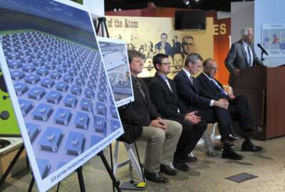 FILE - In this April 29, 2015, file photo, an illustration depicts a planned interim storage facility for spent nuclear fuel in southeastern New Mexico as officials announce plans to pursue a project by Holtec International during a news conference at the National Museum of Nuclear Science and History in Albuquerque, N.M. On Monday, March 29, 2021, New Mexico sued the U.S. Nuclear Regulatory Commission over concerns that the federal agency hasn't done enough to vet plans for a multibillion-dollar facility to store spent nuclear fuel in the state. New Jersey-based Holtec International wants to build a complex in southeastern New Mexico where tons of spent fuel from commercial nuclear power plants around the nation could be stored until the federal government finds a permanent solution. (AP Photo/Susan Montoya Bryan, File)