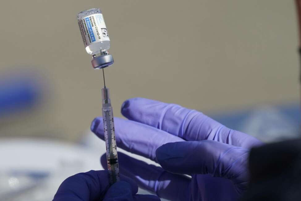 A nurse fills a syringe with COVID-19 vaccine at a mass vaccination site in Kansas City, Mo., Friday, March 19, 2021. (AP Photo/Orlin Wagner)