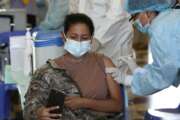 An Air Force member takes a selfie while getting her shot of the Pfizer vaccine for COVID-19 at a military base in Lima, Peru, Monday, March 8, 2021. (AP Photo/Martin Mejia)