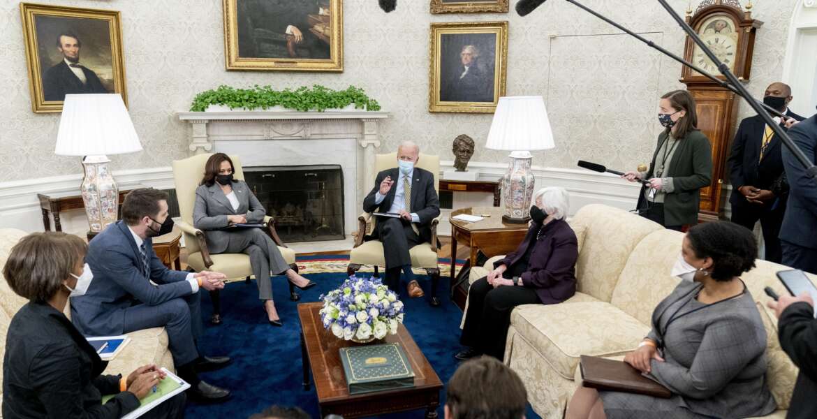 President Joe Biden, accompanied by from left, Council of Economic Advisers chairwoman Cecilia Rouse, National Economic Council director Brian Deese, Vice President Kamala Harris, Treasury Secretary Janet Yellen and Office of Management and Budget acting director Shalanda Young, speaks as he gets his weekly economic briefing in the Oval Office of the White House, Friday, April 9, 2021, in Washington. (AP Photo/Andrew Harnik)