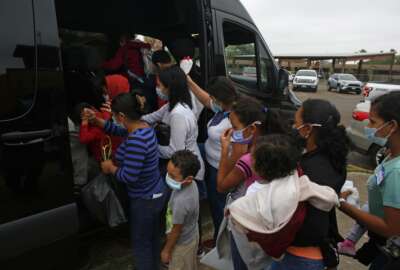 CORRECTS CITY TO MISSION FROM MCALLEN -  Migrants board a van at Our Lady of Guadalupe Catholic Church in Mission, Texas, on Palm Sunday, March 28, 2021. U.S. authorities are releasing migrant families at the border without notices to appear in immigration court and sometimes, without any paperwork at all. (AP Photo/Dario Lopez-Mills)