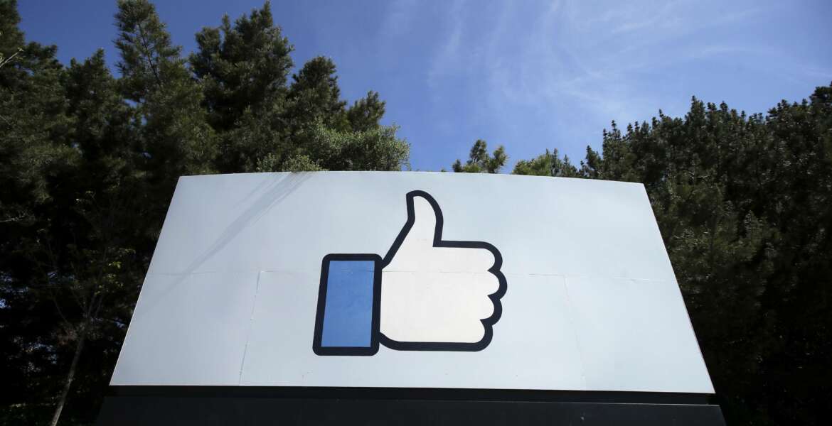 FILE - In this April 14, 2020, file photo, the thumbs up Like logo is shown on a sign at Facebook headquarters in Menlo Park, Calif. Facebook said Tuesday, April 6, 2021, it has removed hundreds of fake accounts linked to an Iranian exile group and a troll farm in Albania. (AP Photo/Jeff Chiu, File)