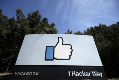 FILE - In this April 14, 2020, file photo, the thumbs up Like logo is shown on a sign at Facebook headquarters in Menlo Park, Calif. Facebook said Tuesday, April 6, 2021, it has removed hundreds of fake accounts linked to an Iranian exile group and a troll farm in Albania. (AP Photo/Jeff Chiu, File)