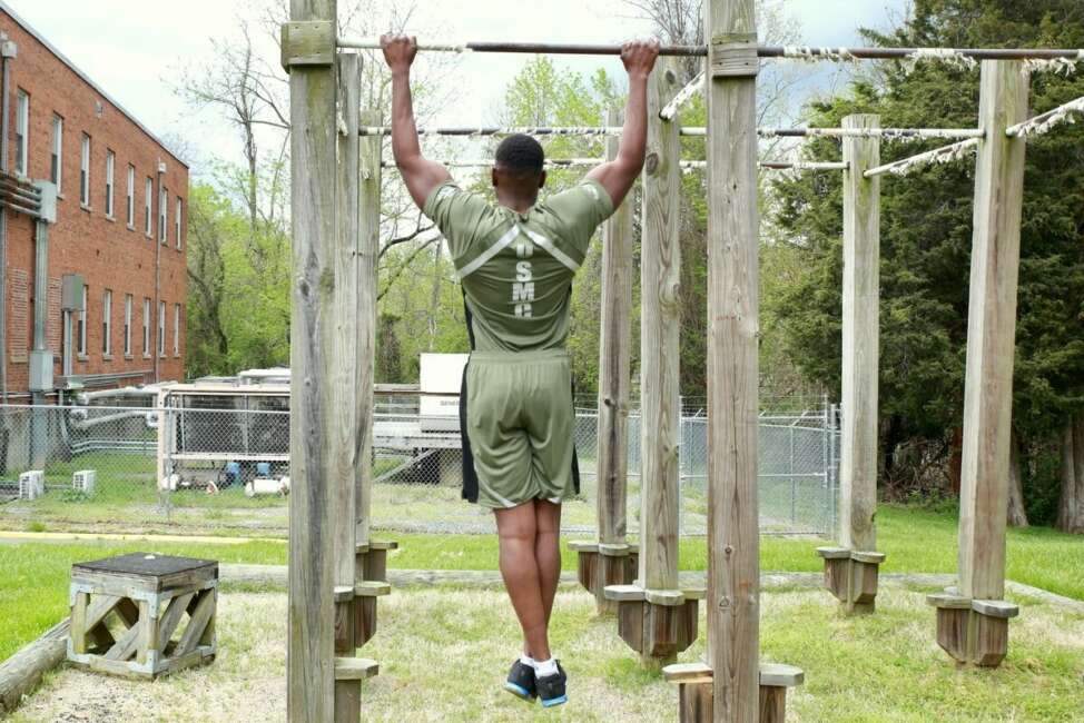 Capt. Donovan Holloway, an intelligence officer at Marine Corps Systems Command, demonstrates a prototype version of the new physical training uniform.