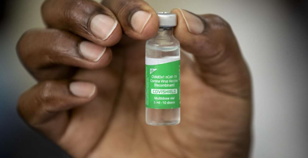 FILE - In this Friday, March 5, 2021 file photo, a nurse holds a vial of AstraZeneca COVID-19 vaccine manufactured by the Serum Institute of India and provided through the global COVAX initiative, at Kenyatta National Hospital in Nairobi, Kenya. Some Africans are hesitating to get COVID-19 vaccines amid concerns about their safety, alarming public health officials as some countries start to destroy thousands of doses that expired before use. (AP Photo/Ben Curtis, File)