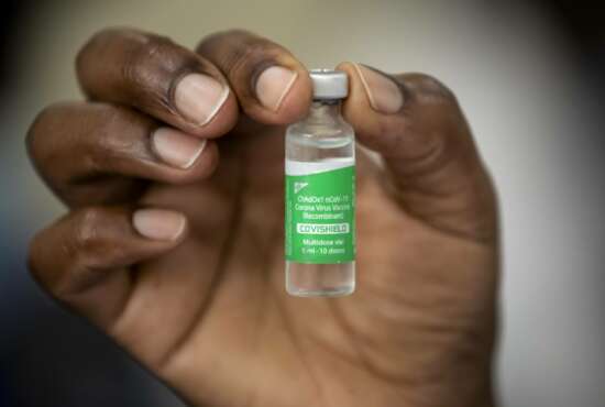 FILE - In this Friday, March 5, 2021 file photo, a nurse holds a vial of AstraZeneca COVID-19 vaccine manufactured by the Serum Institute of India and provided through the global COVAX initiative, at Kenyatta National Hospital in Nairobi, Kenya. Some Africans are hesitating to get COVID-19 vaccines amid concerns about their safety, alarming public health officials as some countries start to destroy thousands of doses that expired before use. (AP Photo/Ben Curtis, File)