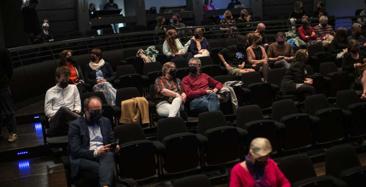 FILE - In this Wednesday, April 28, 2021 file photo, spectators, wearing protective face masks and keeping a social distance, watch the theatre play 