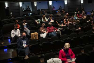 FILE - In this Wednesday, April 28, 2021 file photo, spectators, wearing protective face masks and keeping a social distance, watch the theatre play 