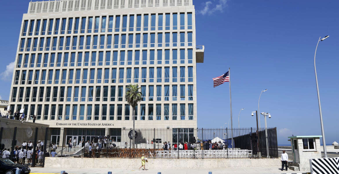 FILE - In this Aug. 14, 2015, file photo, a U.S. flag flies at the U.S. embassy in Havana, Cuba. The United States is renewing calls for the Cuban government to determine the source of “attacks” on U.S. diplomats in Cuba that have affected some two dozen people. At a senior-level meeting with Cuban officials in Washington on June 14, 2018, the State Department said it had again raised the issue, which has prompted a significant reduction in staffing at the U.S. Embassy in Havana.(AP Photo/Desmond Boylan, File)