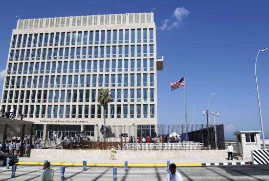 FILE - In this Aug. 14, 2015, file photo, a U.S. flag flies at the U.S. embassy in Havana, Cuba. The United States is renewing calls for the Cuban government to determine the source of “attacks” on U.S. diplomats in Cuba that have affected some two dozen people. At a senior-level meeting with Cuban officials in Washington on June 14, 2018, the State Department said it had again raised the issue, which has prompted a significant reduction in staffing at the U.S. Embassy in Havana.(AP Photo/Desmond Boylan, File)