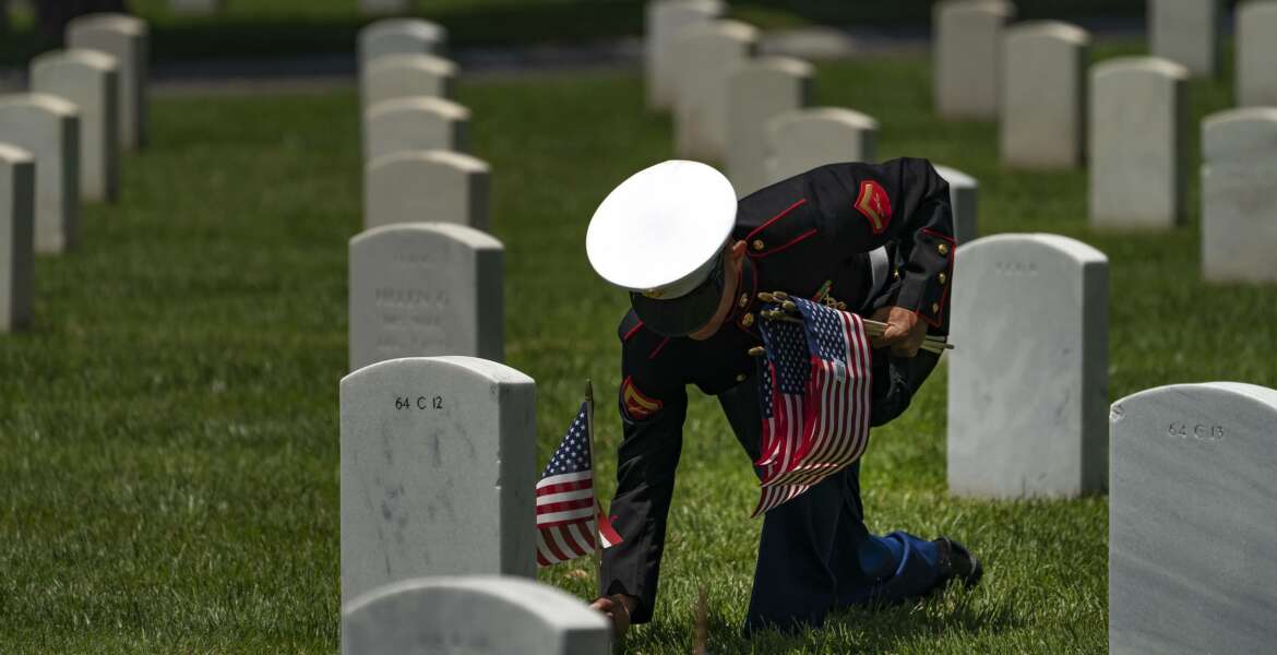 CORRECTS YEAR A U.S. Marine Corps, who wants to remain anonymous, honors veterans graves at the Los Angeles National Cemetery in Los Angeles, Monday, May 31, 2021. He has placed American flags for the last 15-years, first as a boy scout, this year as a U.S. Marine. Authorities said a giant American flag and several smaller flags were stolen from a Southern California veterans cemetery over the Memorial Day weekend. Les' Melnyk, a spokesperson for the Department of Veterans Affairs National Cemetery Administration, said the garrison flag at Los Angeles National Cemetery was reported stolen sometime late Sunday or early Monday. (AP Photo/Damian Dovarganes)