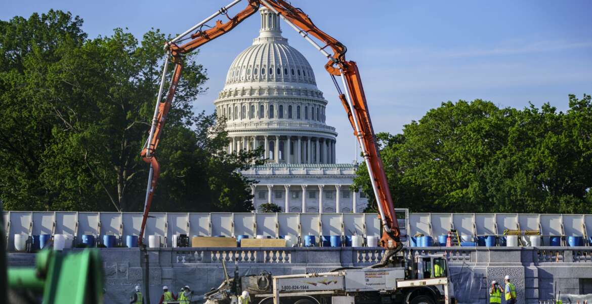 A concrete pump frames the Capitol Dome during renovations and repairs to Lower Senate Park on Capitol Hill in Washington, Tuesday, May 18, 2021. President Joe Biden hopes to pass a massive national infrastructure plan by this summer but Democrats and Republicans in Congress appear divided over his proposal for $2.3 trillion in spending to upgrade the nation's crumbling infrastructure. (AP Photo/J. Scott Applewhite)
