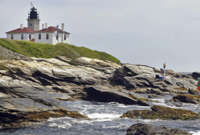FILE - In this July 7, 2006, file photograph, fishermen cast on the rocky shore at the Beavertail Lighthouse, the third-oldest lighthouse in America, at the tip of Beavertail State Park, on Narragansett Bay, in Jamestown, R.I. The federal government's General Services Administration announced the U.S. Coast Guard has decided it no longer needs four of the nation's most storied and picturesque lighthouses, including the Beavertail Lighthouse. The government says it'll make the historic lighthouses and their outbuildings available at no cost to federal, state and local agencies; nonprofit organizations; educational and community development agencies; or groups devoted to parks, recreation, culture, or historic preservation. (AP Photo/Stew Milne, File)