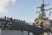 In this photo provided by the U.S. Navy, sailors aboard the guided missile destroyer USS Stout handle mooring lines during the ship's return to home port at Naval Station Norfolk, in Norfolk, Va., in this Oct. 12, 2020, photo. The USS Stout showed rust as it returned from the 210-day deployment. The rust was quickly removed and the ship repainted. But the rusty ship and its weary crew underscored the costly toll of deferred maintenance on ships and long deployments on sailors. (Spc. Jason Pastrick/U.S. Navy via AP)