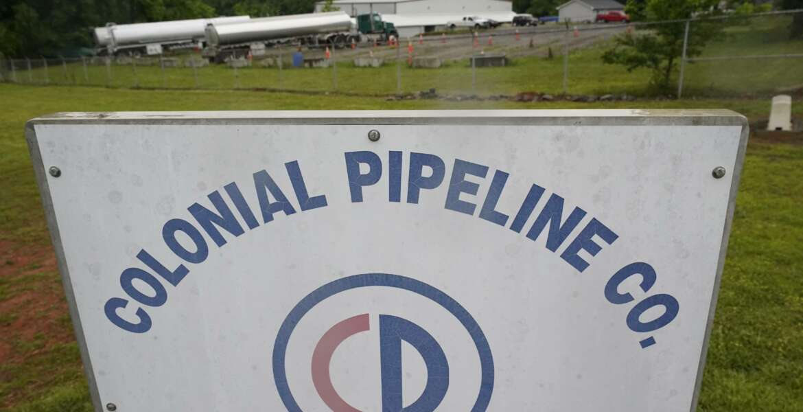 Tanker trucks are parked near the entrance of Colonial Pipeline Company Wednesday, May 12, 2021, in Charlotte, N.C.  Several gas stations in the Southeast reported running out of fuel, primarily because of what analysts say is unwarranted panic-buying among drivers, as the shutdown of a major pipeline by hackers entered its fifth day.  (AP Photo/Chris Carlson)