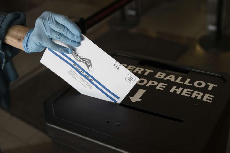 FILE - In this May 28, 2020, file photo a voter casts her mail-in ballot at in a drop box in West Chester, Pa., prior to the primary election. Former President Donald Trump’s discredited allegations about a stolen election did nothing to save his presidency months ago. Courtrooms, state governments and ultimately Congress affirmed the legitimacy of his defeat and the honesty of the process. (AP Photo/Matt Rourke, File)