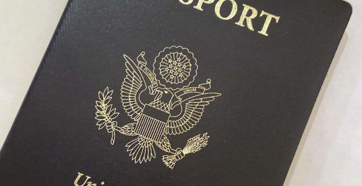 This May 25, 2021 photo shows a U.S. Passport cover in Washington.  The Biden administration says American citizens holding recently expired U.S. passports will be allowed to return home from abroad on that document until the end of year. (AP Photo/Eileen Putman)