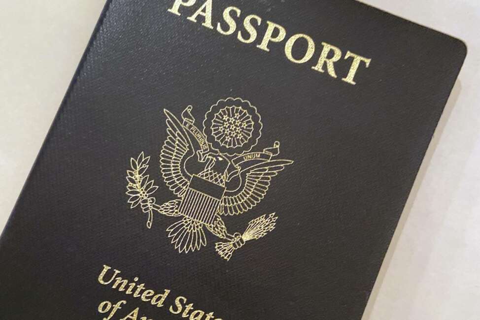 This May 25, 2021 photo shows a U.S. Passport cover in Washington.  The Biden administration says American citizens holding recently expired U.S. passports will be allowed to return home from abroad on that document until the end of year. (AP Photo/Eileen Putman)