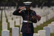 A U.S. Marine Corps, who wants to remain anonymous, salutes veterans at the Los Angeles National Cemetery in Los Angeles, Monday, May 31, 2021. He has been honoring American veterans's graves for the last 15-years, first as a boy scout, this year as a U.S. Marine. Authorities said a giant American flag and several smaller flags were stolen from a Southern California veterans cemetery over the Memorial Day weekend. Les' Melnyk, a spokesperson for the Department of Veterans Affairs National Cemetery Administration, said the garrison flag at Los Angeles National Cemetery was reported stolen sometime late Sunday or early Monday. (AP Photo/Damian Dovarganes)