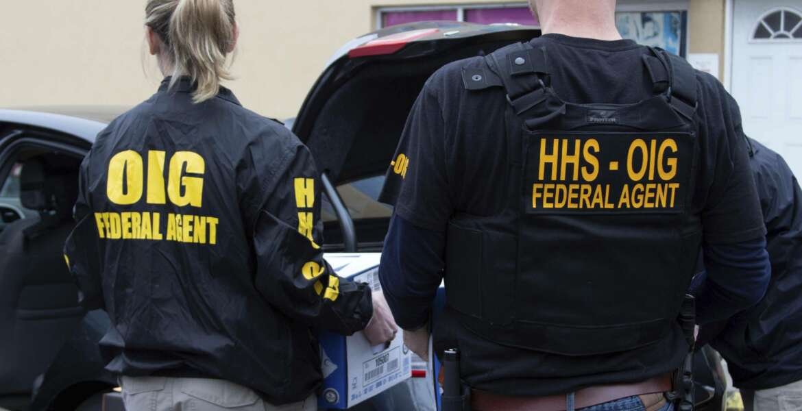 In this image provided by the Department of Health and Human Services, federal agents from Department of Health and Human Services Office of Inspector General engage in search warrant operations at a laboratory in Atlanta. More than 35 individuals associated with telemedicine companies and cancer genetic testing laboratories were charged for actions related to fraudulent genetic testing. The Justice Department announced charges on May 26, 2021, against more than a dozen people from Florida to California in a series of Medicare scams that exploited coronavirus fears to bill tens of millions of dollars in bogus claims. (Department of Health and Human Services via AP)