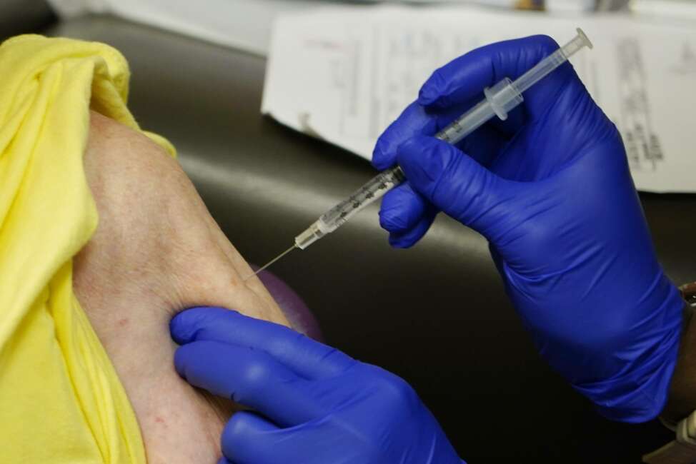 In this April 7, 2021 photo, a senior receives the Johnson &amp; Johnson COVID-19 vaccine at the Aaron E. Henry Community Health Service Center, in Clarksdale, Miss. Medicare will require nursing homes to report COVID-19 vaccination rates for residents and staff, the government said Tuesday, in what officials hope will become an incentive to keep giving shots even as the worst ravages of the pandemic ease in facilities across the land.(AP Photo/Rogelio V. Solis)