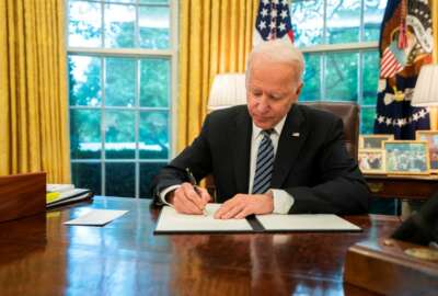 President Joe Biden signs the cybersecurity executive order on May 12.
