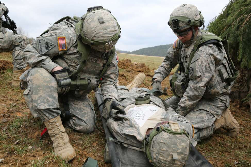 U.S. Soldiers assigned to Bravo Troop, 1st Squadron, 2nd Cavalry Division strap in a simulated wounded Soldier to a litter while conducting a movement to contact drill during exercise Saber Junction 15 at the U.S. Army’s Joint Multinational Readiness Center in Hohenfels, Germany, April 12, 2015. Saber Junction 15 prepares NATO and partner nation forces for offensive, defensive, and stability operations and promotes interoperability among participants. Saber Junction 15 has more than 4,700 participants from 17 countries, to include: Albania, Armenia, Belgium, Bosnia, Bulgaria, Great Britain, Hungary, Latvia, Lithuania, Luxembourg, Macedonia, Moldova, Poland, Romania, Sweden, Turkey, and the U.S. (U.S. Army photo by Spc. Brian Chaney/Released) (Spc. Brian Chaney)

