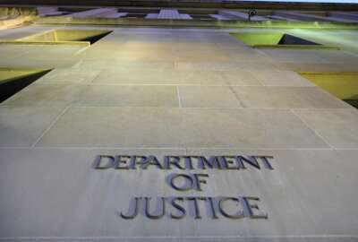 FILE - In this May 14, 2013, file photo, the Department of Justice headquarters building in Washington is photographed early in the morning. (AP Photo/J. David Ake, File)