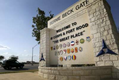 FILE - In this July 9, 2013, file photo, traffic flows through the main gate past a welcome sign in Fort Hood, Texas. A new study finds that female soldiers at Army bases in Texas, Colorado, Kansas and Kentucky face a greater risk of sexual assault and harassment than those at other posts, accounting for more than a third of all active duty Army women sexually assaulted in 2018. The study by RAND Corporation was released Friday.  (AP Photo/Tony Gutierrez, File)