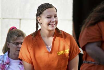 FILE- In this June 26, 2018 file photo, Reality Winner walks into the Federal Courthouse in Augusta, Ga. Winner, 29, a former government contractor who was given the longest federal prison sentence imposed for leaks to the news media, has been released from prison to home confinement, a person familiar with the matter told The Associated Press on Monday. (Michael Holahan/The Augusta Chronicle via AP, File)