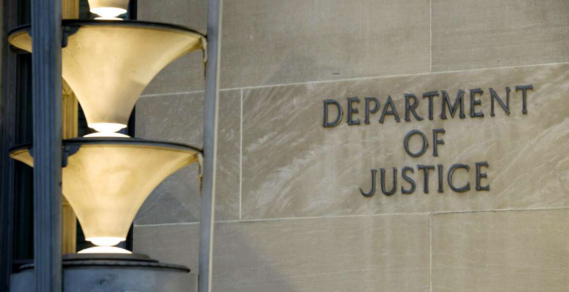 The Department of Justice is seen, Friday, March 22, 2019, in Washington. The Justice Department under former President Donald Trump secretly seized data from the accounts of at least two Democratic lawmakers in 2018 as part of an aggressive crackdown on leaks related to the Russia investigation and other national security matters, according to three people familiar with the seizures.  (AP Photo/Alex Brandon)