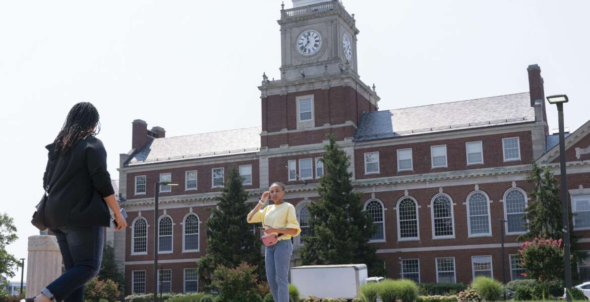 FILE - In this July 6, 2021, file photo with the Founders Library in the background, people walk along the Howard University campus in Washington. With the surprise twin hiring of two of the country's most prominent writers on race, Howard University is positioning itself as one of the primary centers of Black academic thought just as America struggles through a painful crossroads over historic racial injustice. (AP Photo/Jacquelyn Martin, File)