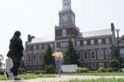 FILE - In this July 6, 2021, file photo with the Founders Library in the background, people walk along the Howard University campus in Washington. With the surprise twin hiring of two of the country's most prominent writers on race, Howard University is positioning itself as one of the primary centers of Black academic thought just as America struggles through a painful crossroads over historic racial injustice. (AP Photo/Jacquelyn Martin, File)