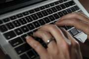 FILE- In this June 19, 2017, file photo, a person types on a laptop keyboard in North Andover, Mass.  A new report by a global media consortium that expands the known target list of the Israeli hacker-for-hire firm NSO Group’s military-grade spyware provoked alarm Monday, July 19, 2021,  among human rights and press freedom activists. They decried the near-complete absence of regulation of commercial surveillance tools.   (AP Photo/Elise Amendola, File)