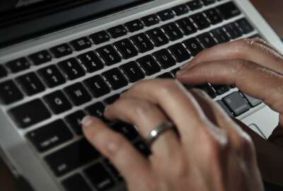 FILE- In this June 19, 2017, file photo, a person types on a laptop keyboard in North Andover, Mass.  A new report by a global media consortium that expands the known target list of the Israeli hacker-for-hire firm NSO Group’s military-grade spyware provoked alarm Monday, July 19, 2021,  among human rights and press freedom activists. They decried the near-complete absence of regulation of commercial surveillance tools.   (AP Photo/Elise Amendola, File)