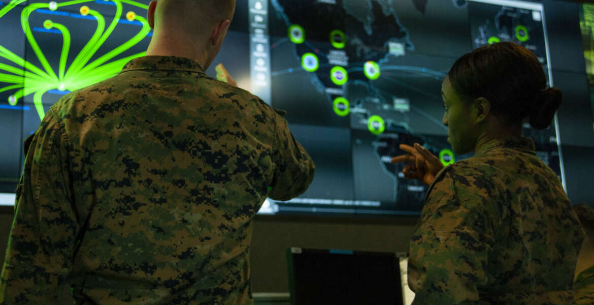 Marines with Marine Corps Forces Cyberspace Command pose for photos in the cyber operations center at Lasswell Hall aboard Fort Meade, Maryland, Feb. 5, 2020. MARFORCYBER Marines conduct offensive and defensive cyber operations in support of United States Cyber Command and operate, secure and defend the Marine Corps Enterprise Network. This image is a photo illustration.