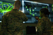 Marines with Marine Corps Forces Cyberspace Command pose for photos in the cybersecurity operations center at Lasswell Hall aboard Fort Meade, Maryland.