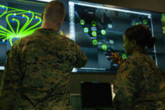Marines with Marine Corps Forces Cyberspace Command pose for photos in the cybersecurity operations center at Lasswell Hall aboard Fort Meade, Maryland.